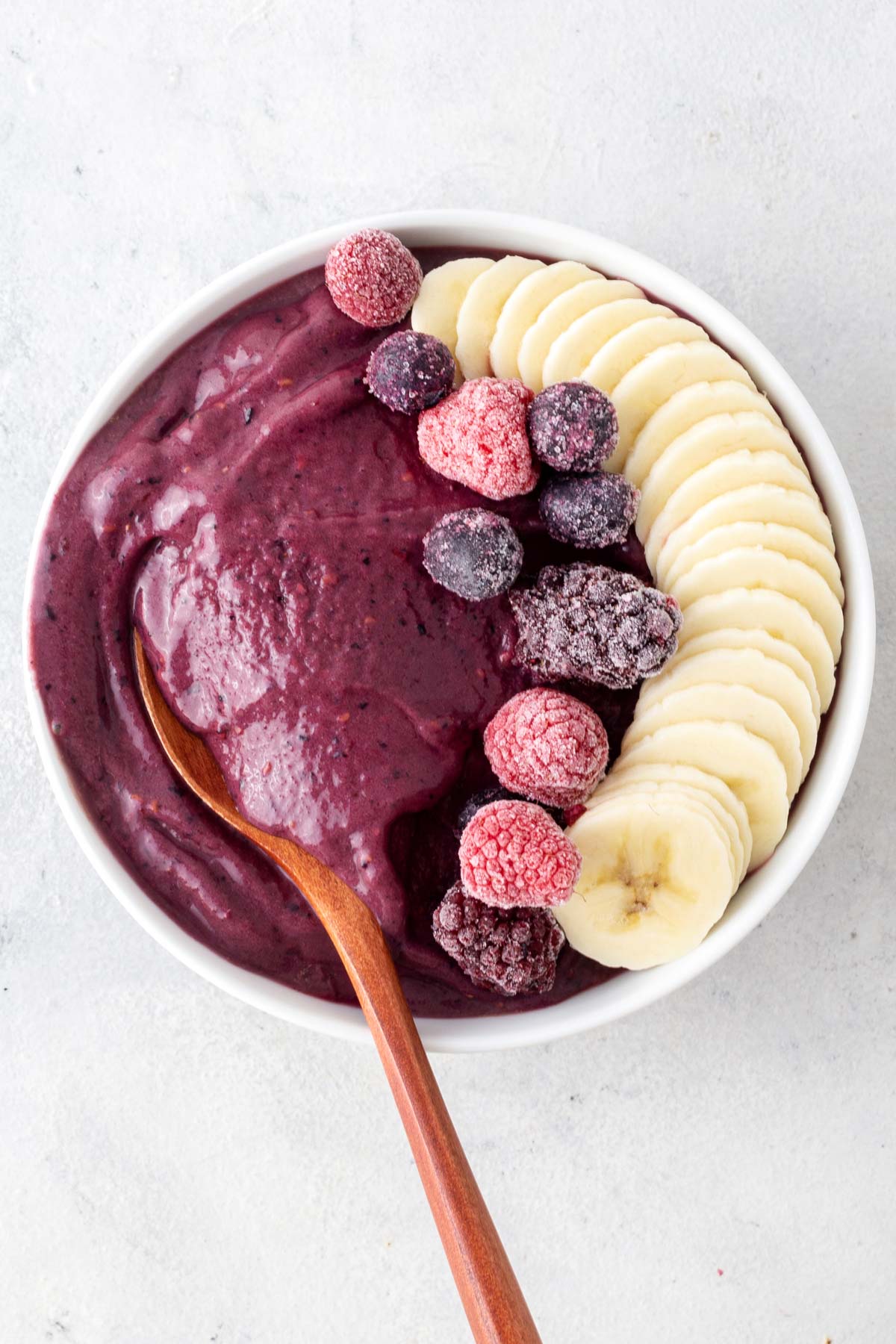 Acai smoothie bowl on a gray table.