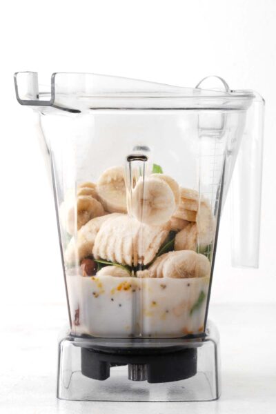 Bananas, spinach, turmeric, ginger, chia seeds, unsweetened almond milk and Medjool date in a blender.