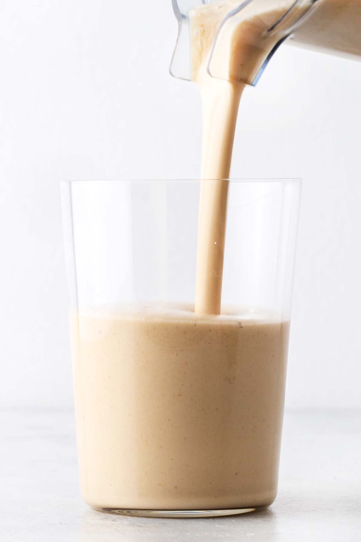 Peanut butter banana protein shake in a glass.