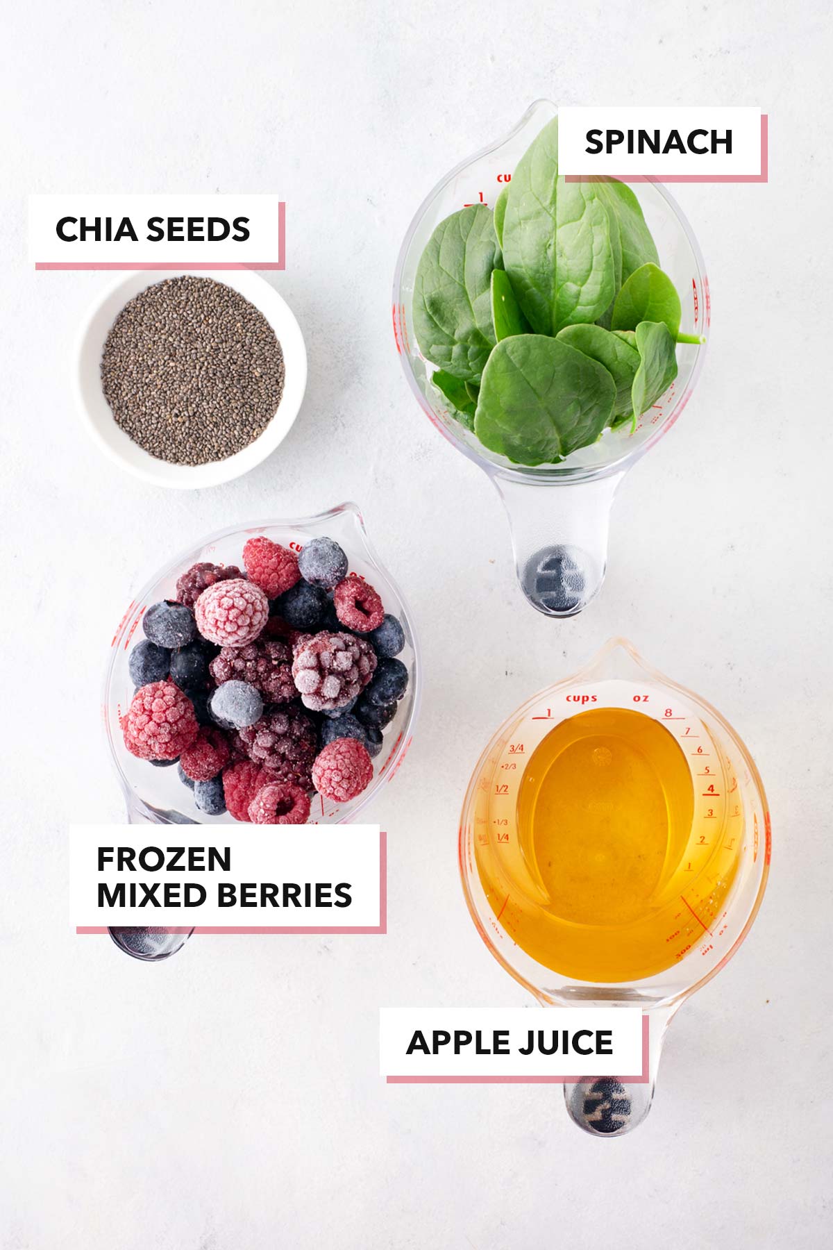 Ingredients for a berry smoothie on a table.
