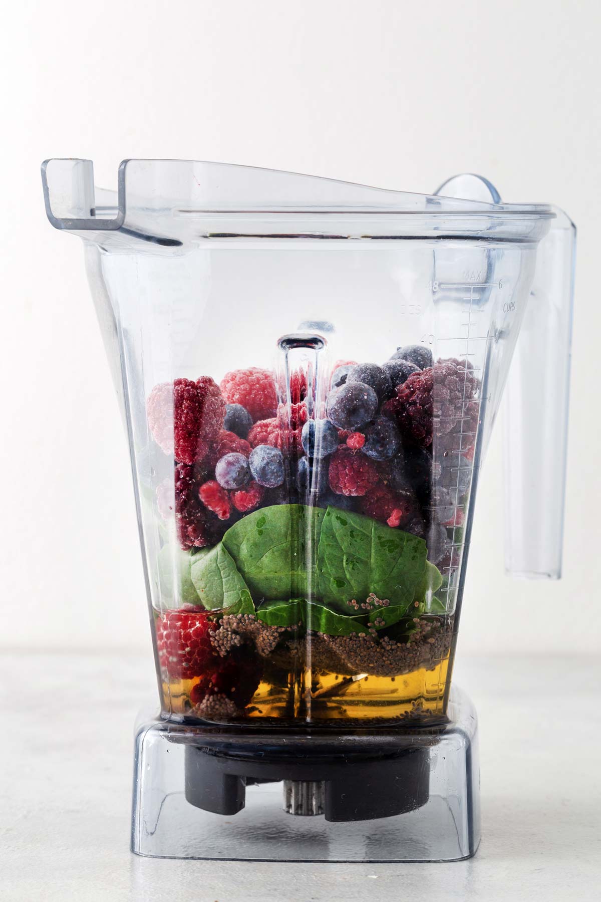 Ingredients for berry smoothie in a blender.