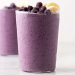 Blueberry banana smoothie in a glass.