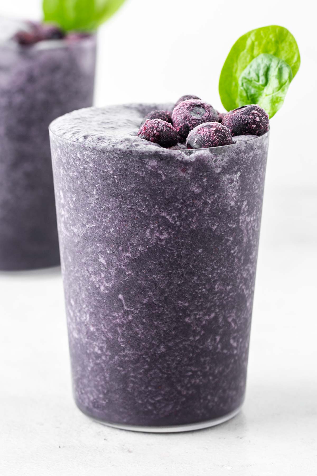 Blueberry collagen smoothie in a glass.