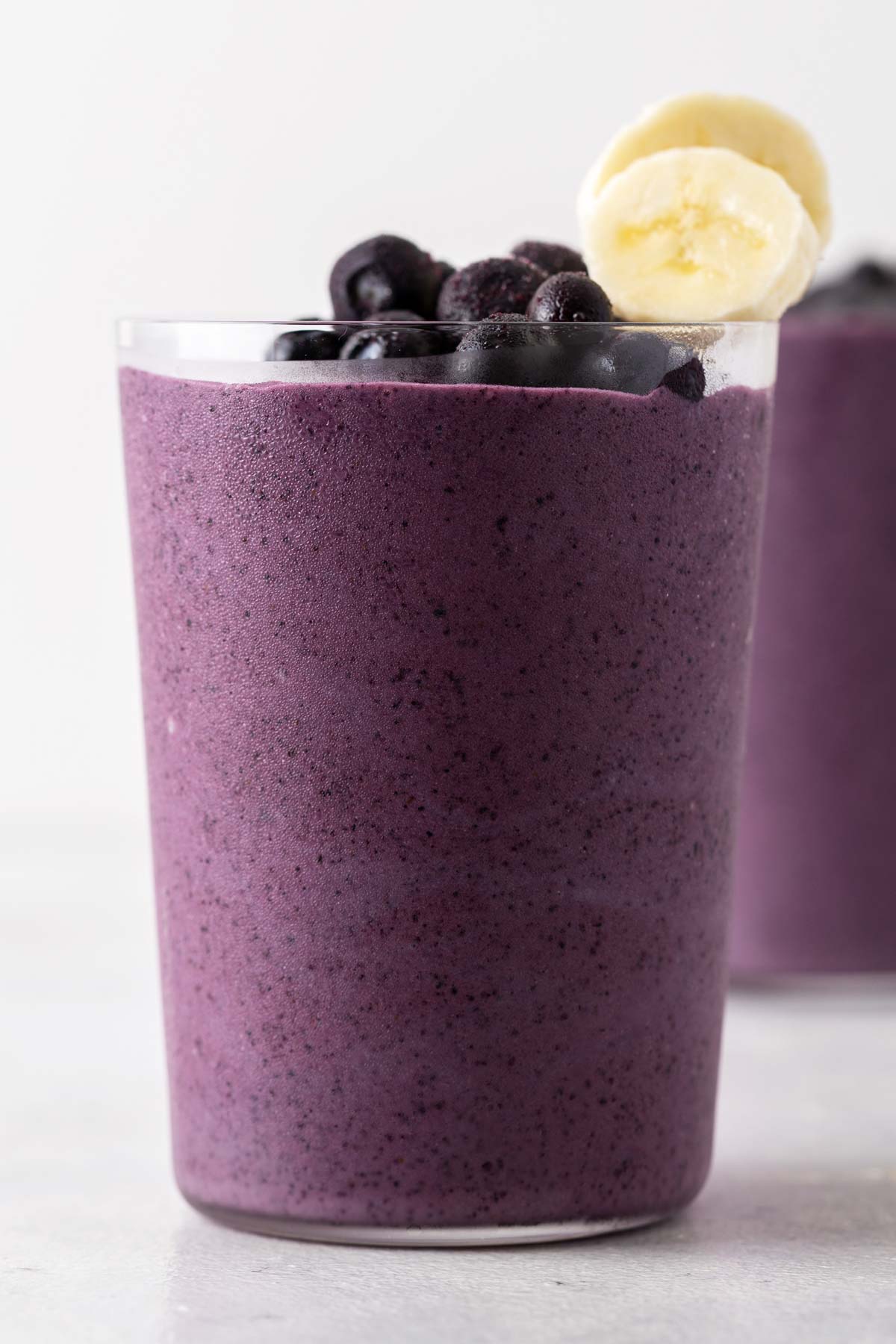 Blueberry smoothie in a cup.