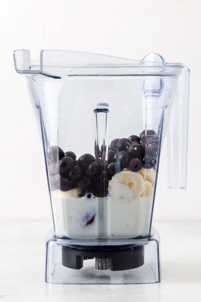 Blueberry, banana, date, yogurt, and milk in a blender. 