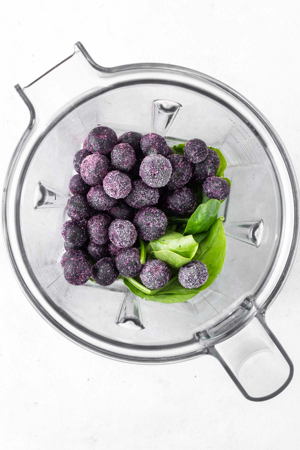 Ingredients for a blueberry smoothie in a blender.