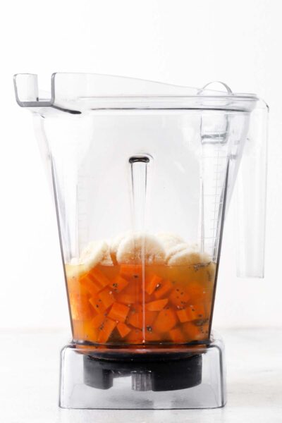 Carrots, frozen bananas, and apple juice in a blender.