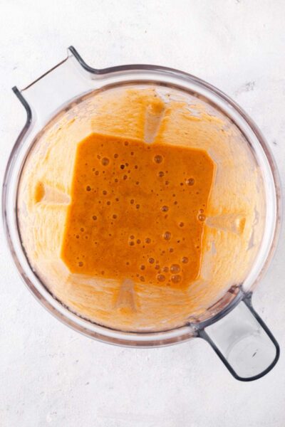 Carrot smoothie blended in a blener until smooth.