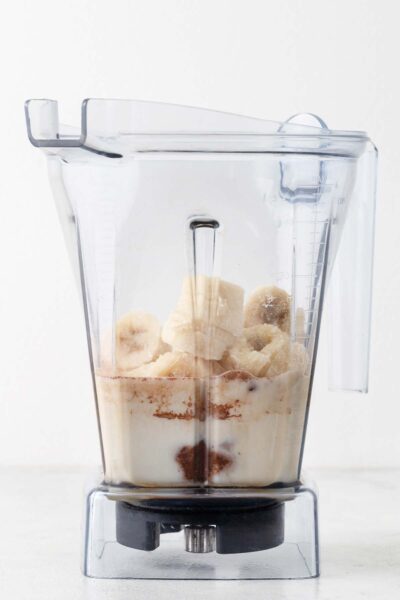 Bananas, collagen powder and cocoa powder, milk and date syrup in a blender.