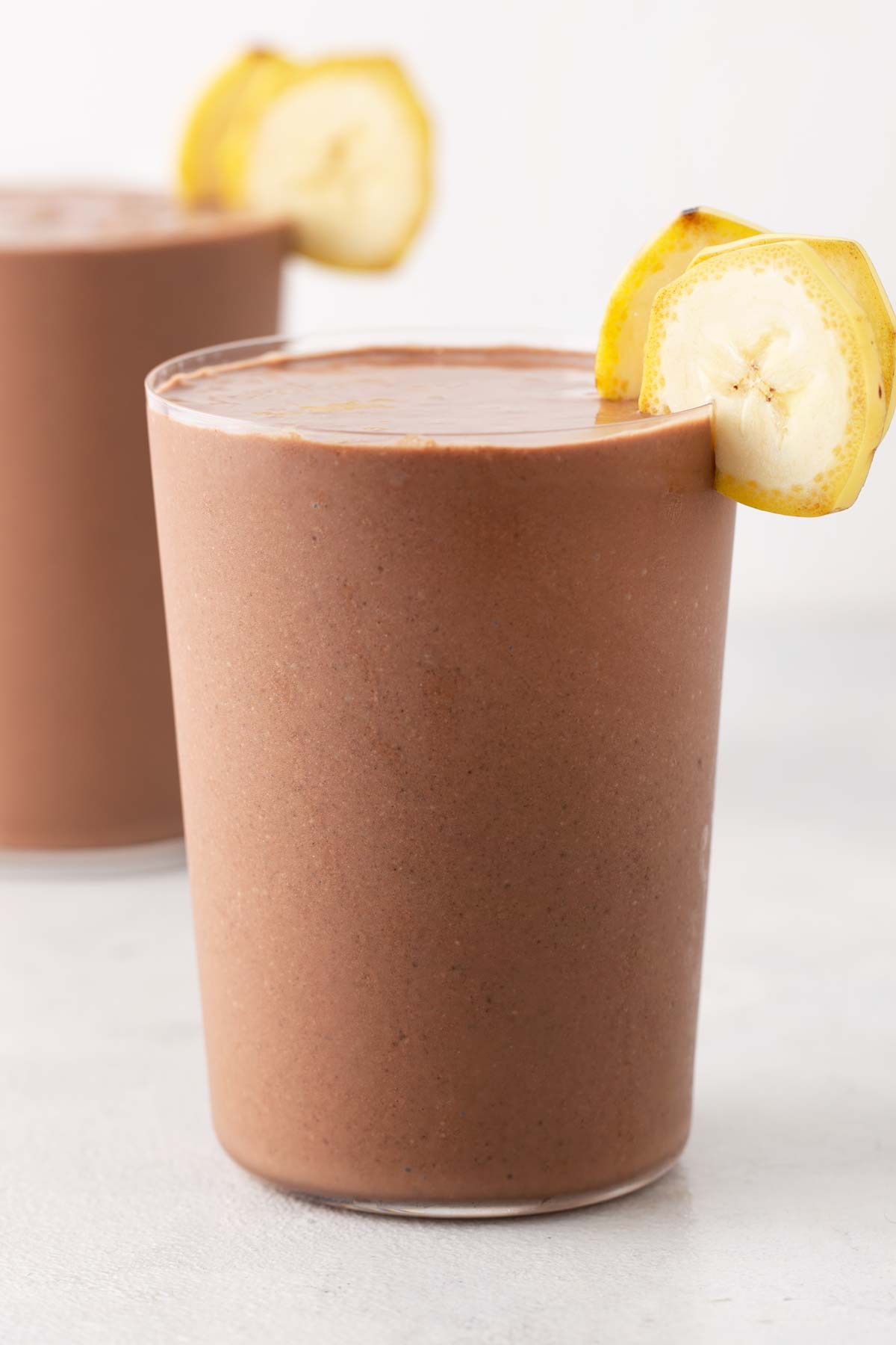Chocolate peanut butter banana smoothie in a glass.