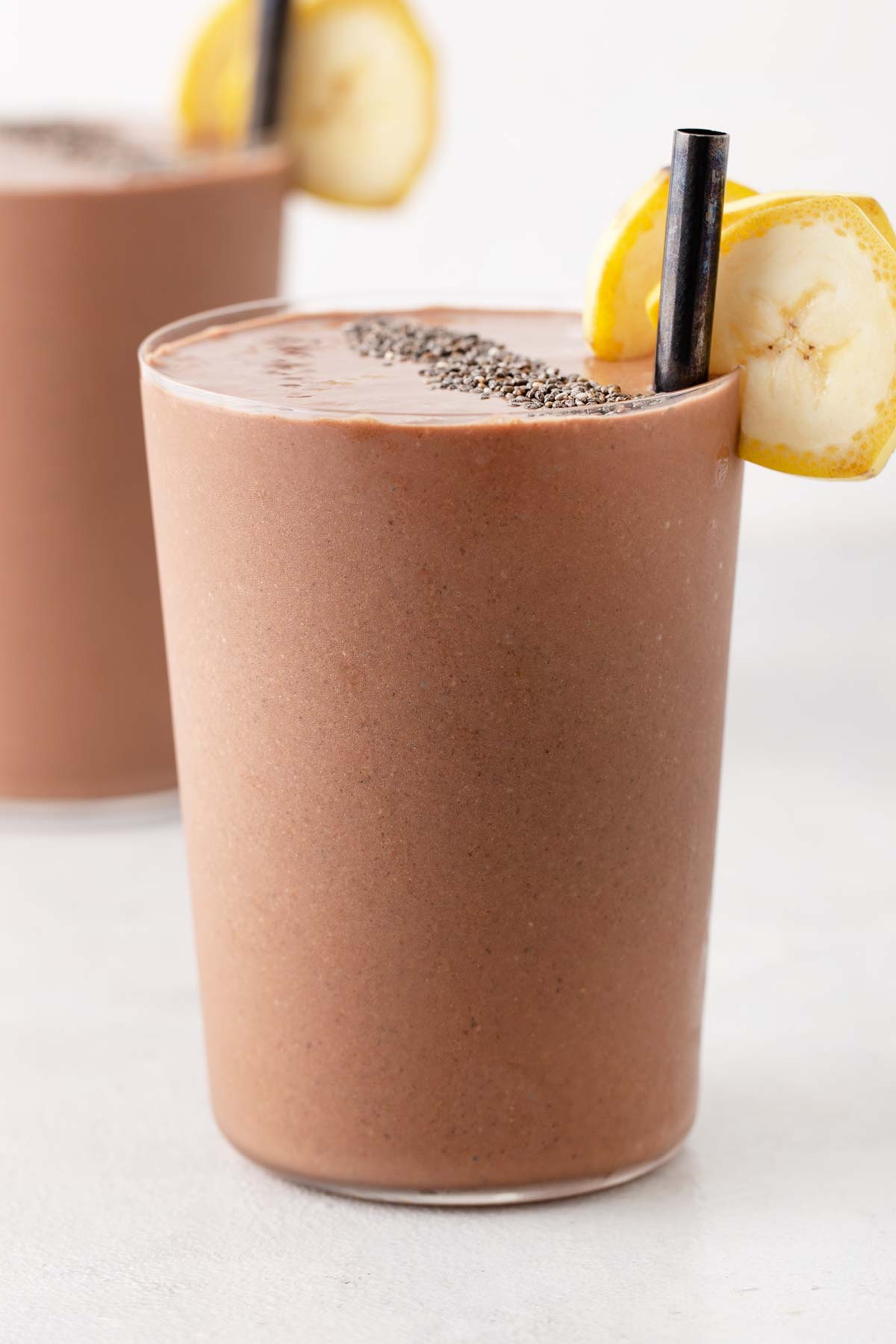 Chocolate peanut butter banana smoothie in a glass.