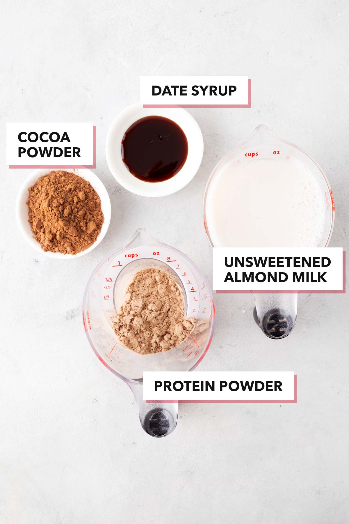Ingredients for a chocolate protein shake on a table.