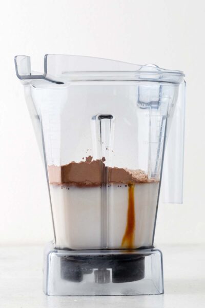 Cocoa powder, chocolate protein powder, date syrup and almond milk in a blender. 