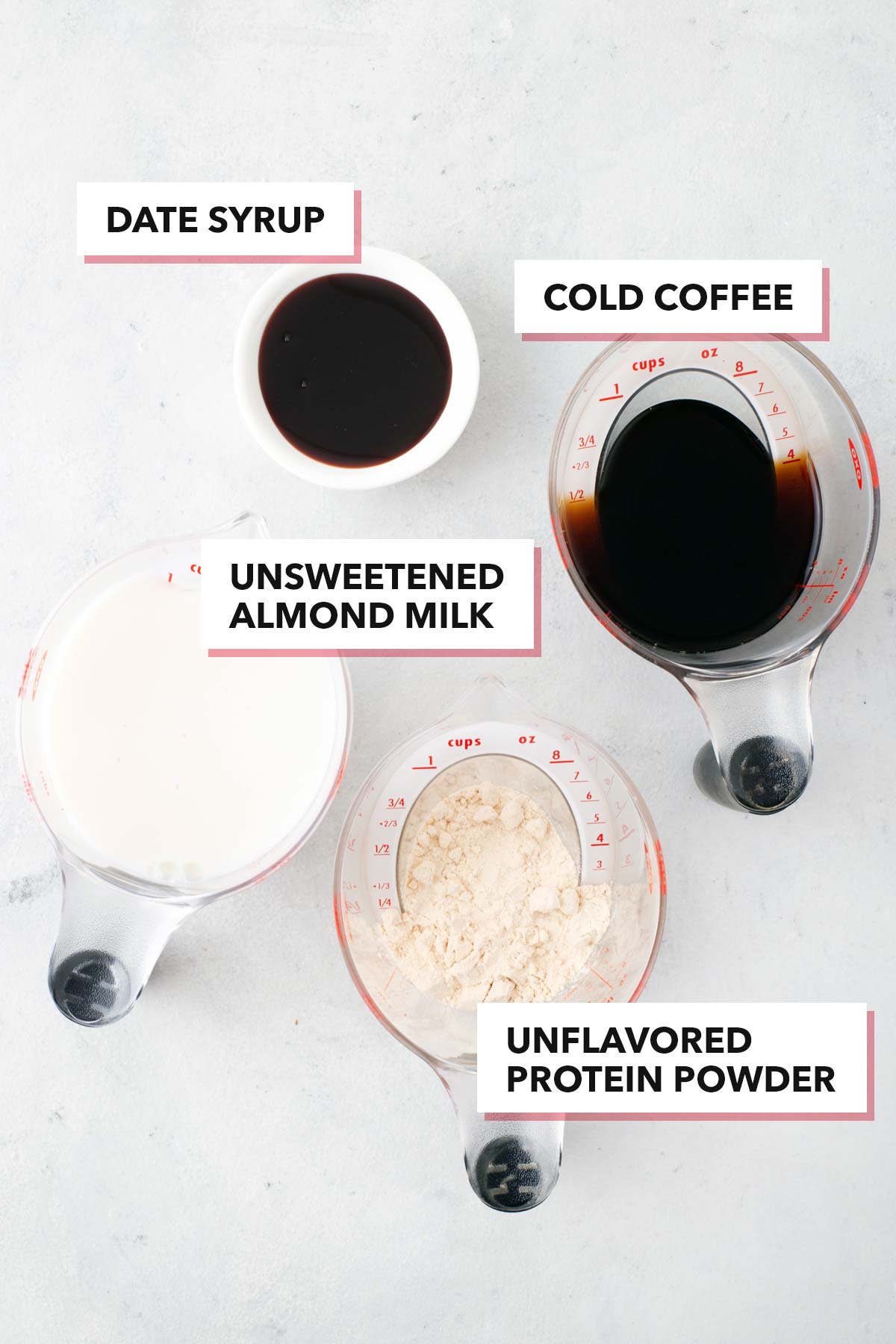 Coffee protein shake ingredients on a white table.