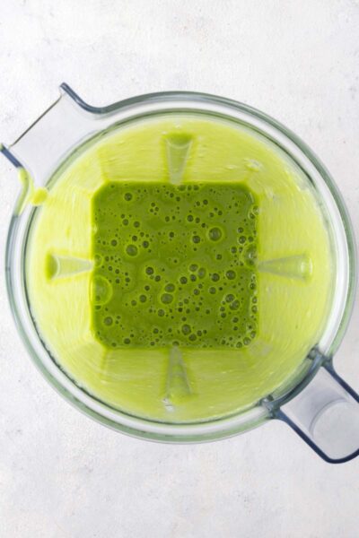 Green smoothie in a blender cup. 