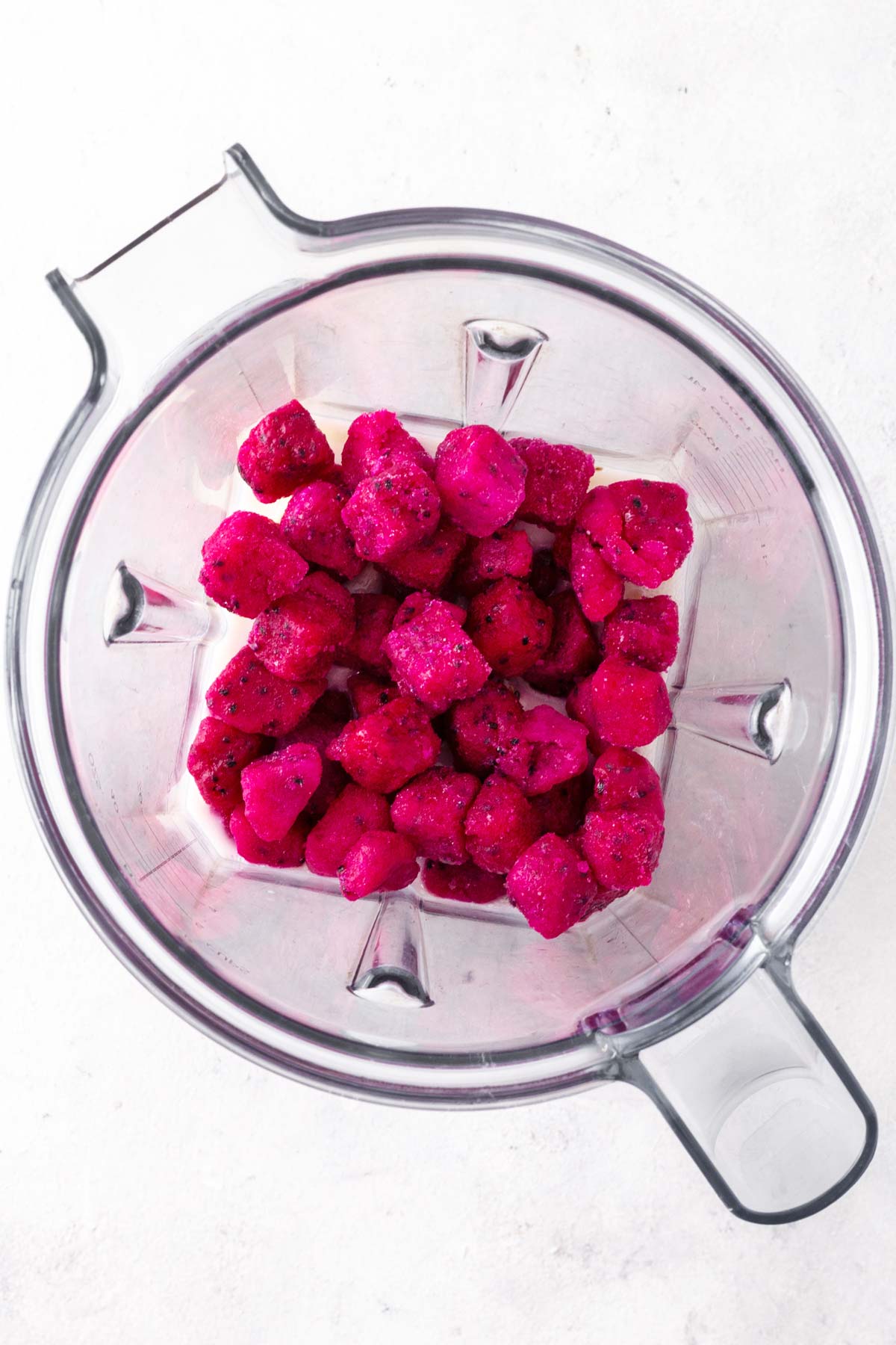 Ingredients for a dragon fruit smoothie in a blender.