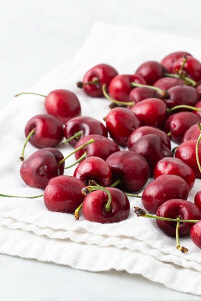Washed cherries on a white towel.