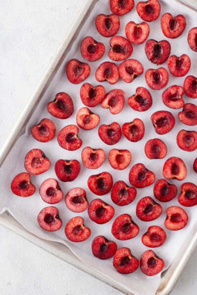 Cherry halves on a baking sheet.