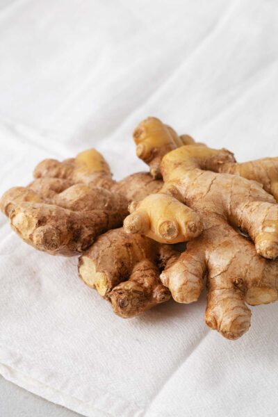 Fresh ginger on a white dish towel.