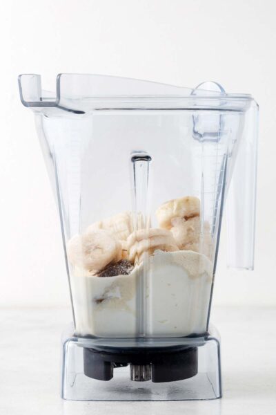 Bananas, a date, greek yogurt, milk in a blender.