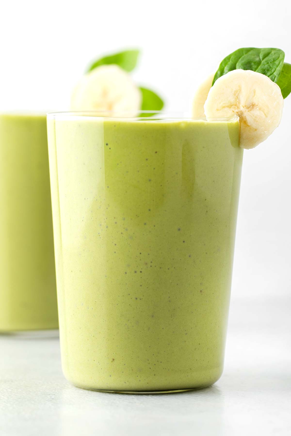 Green protein smoothie in a glass.