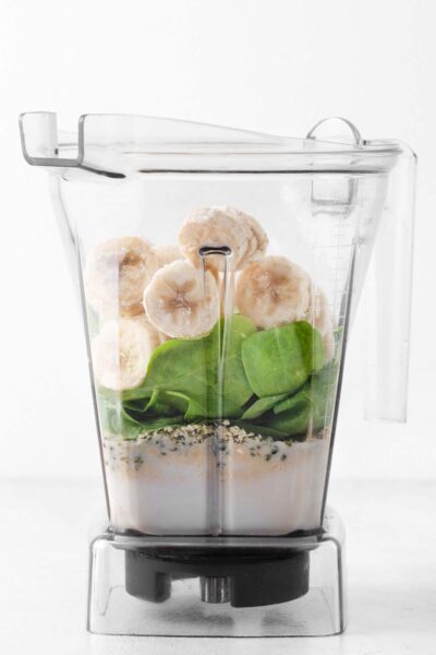 Banana, spinach, chia seeds, date syrup, and milk in a blender. 