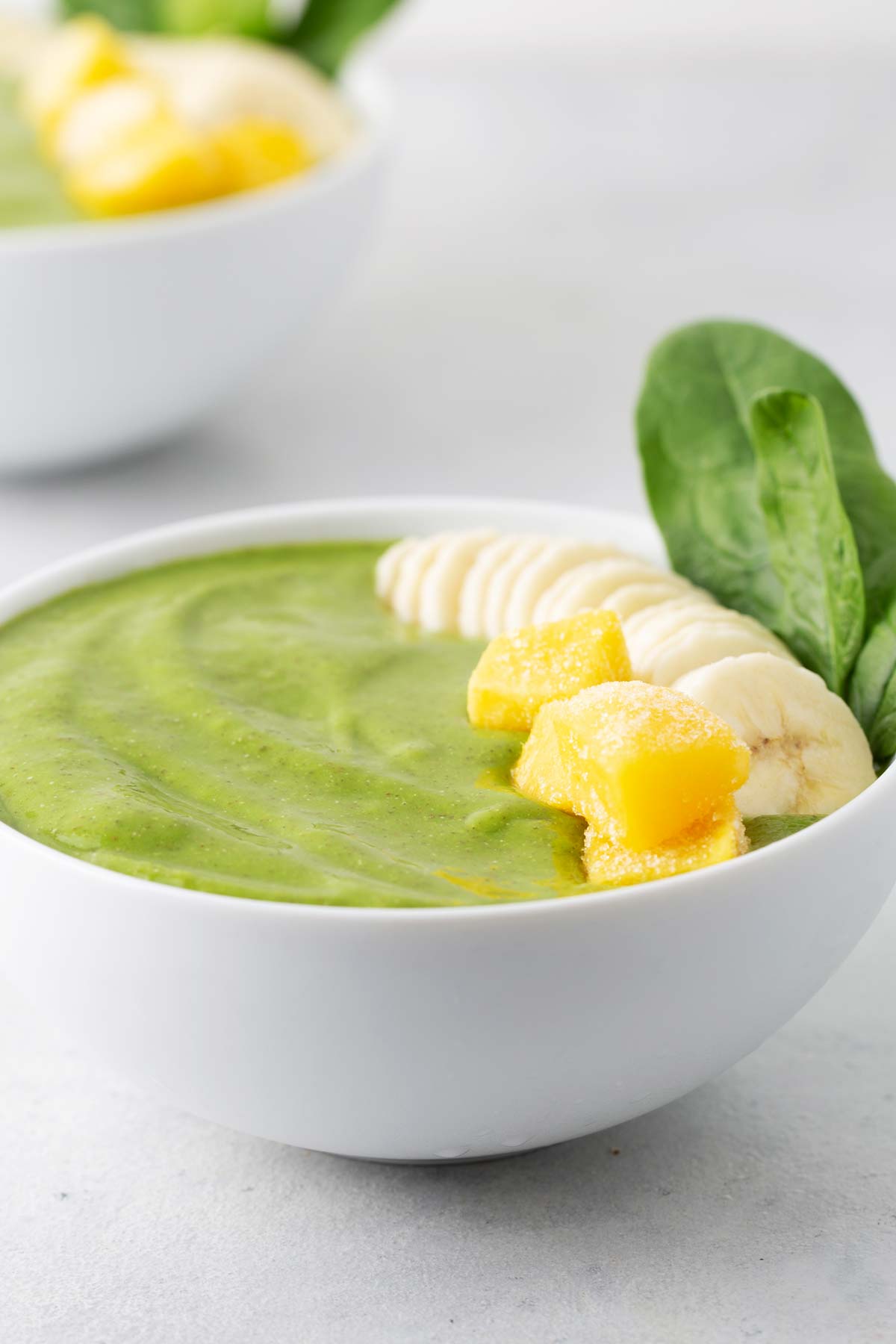 Green smoothie bowl in a white bowl.