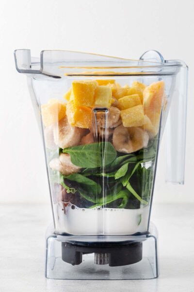 Mango, banana, spinach, chia seeds and milk in a blender. 