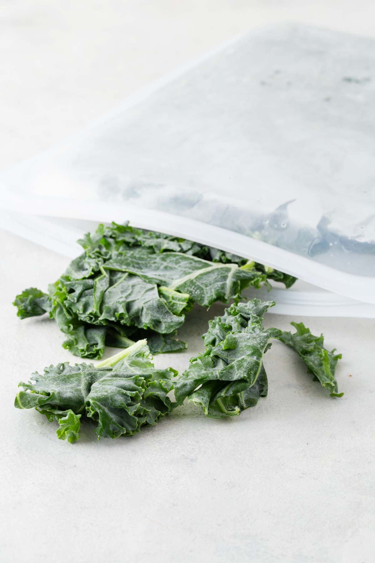Frozen kale in a silicone freezer bag.