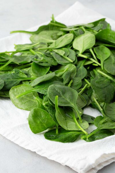 Baby spinach on a white towel.