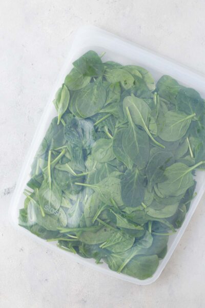 Baby spinach in a reusable silicone storage bag.