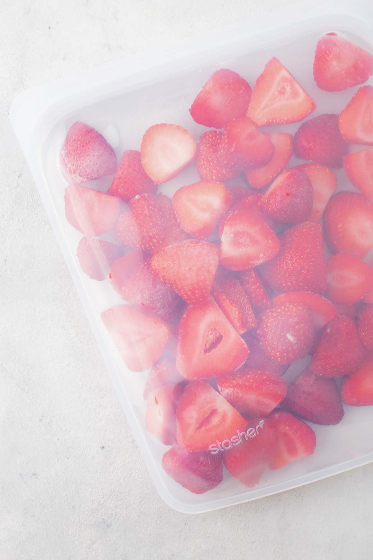 Frozen strawberries in a silicone bag.