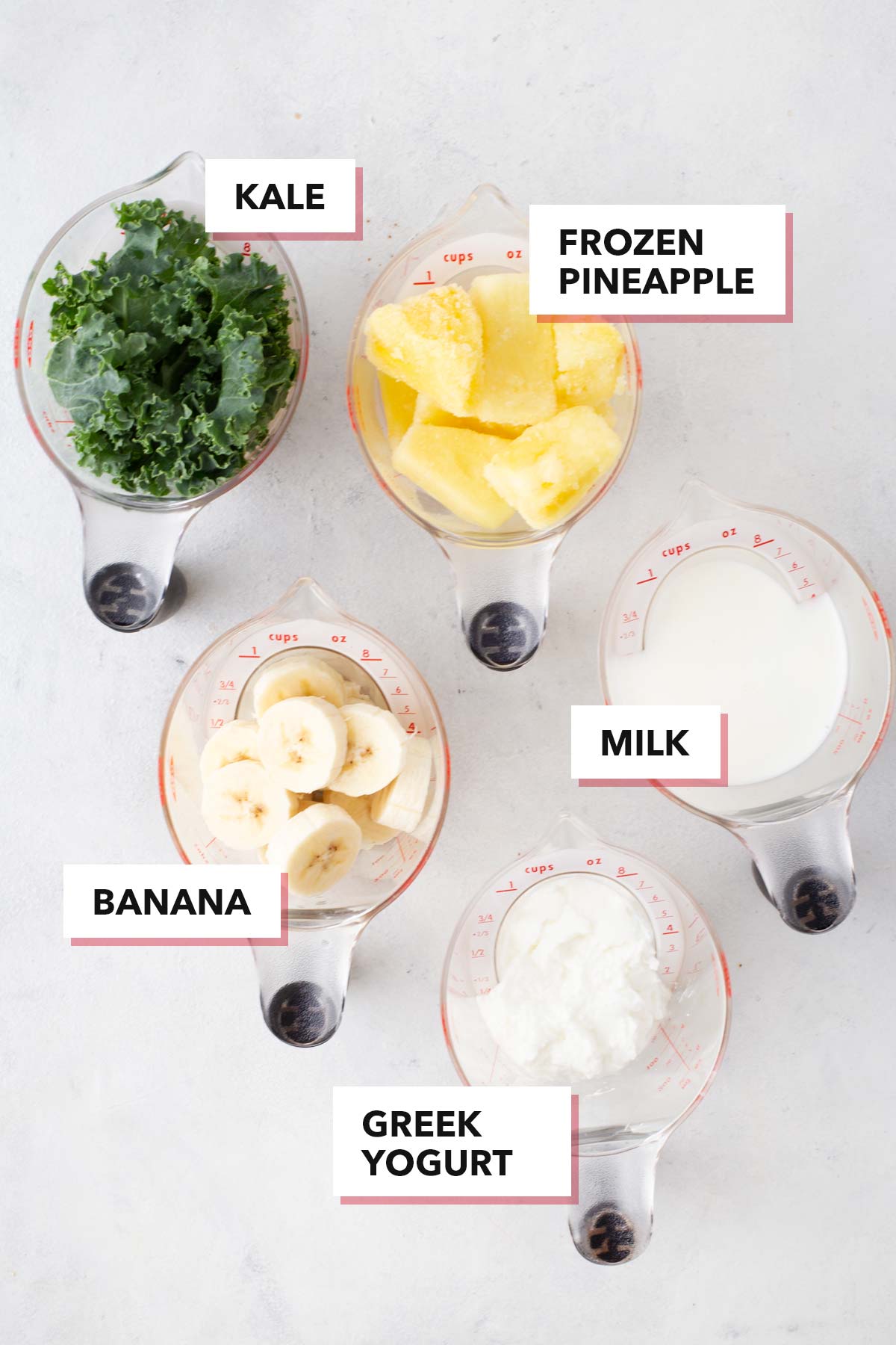 Ingredients for a kale pineapple smoothie on a table.