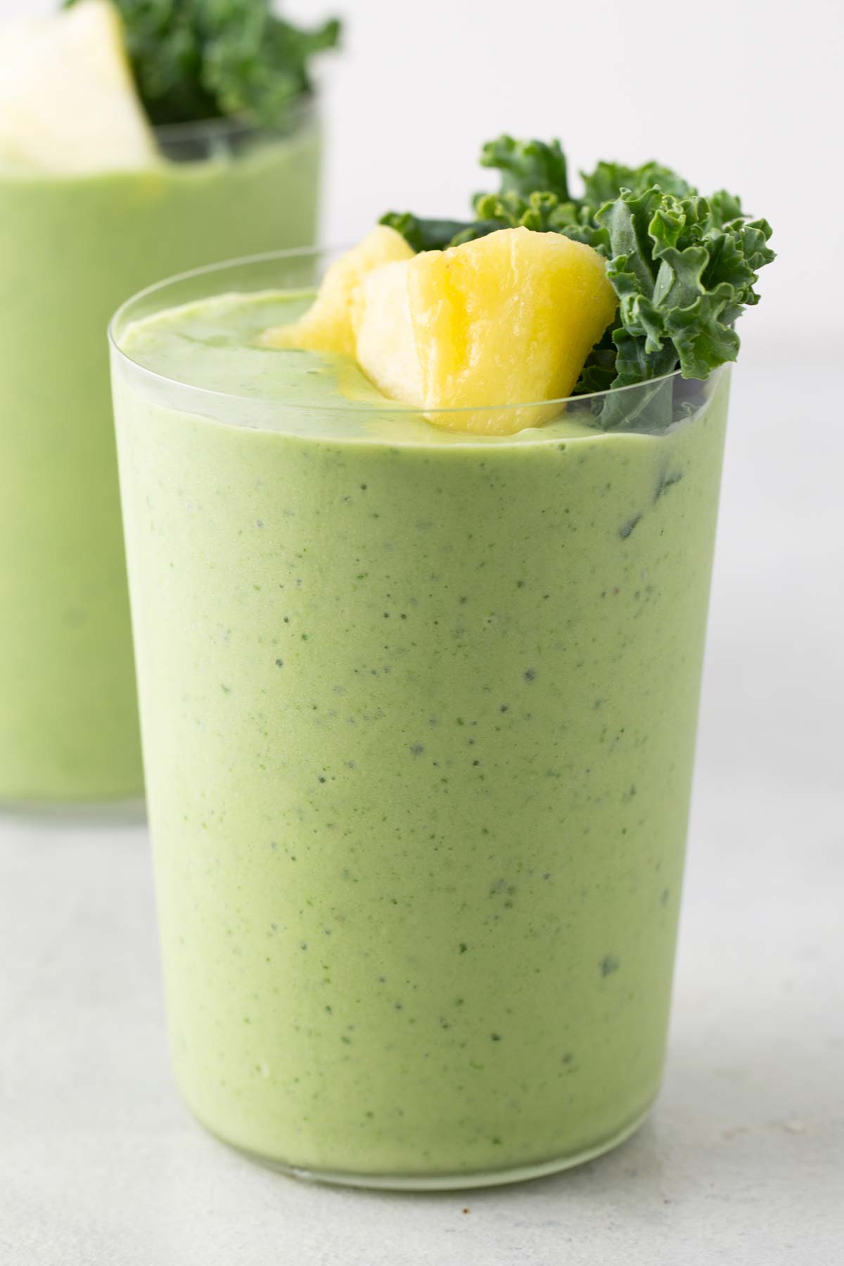 Kale pineapple smoothie in a cup.