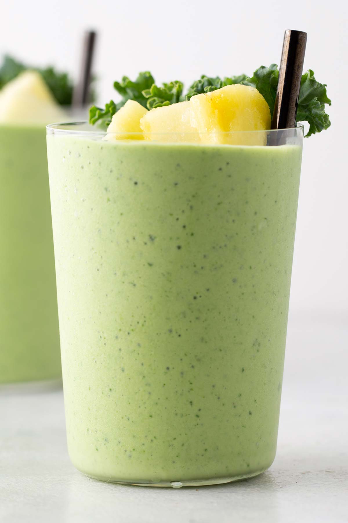 Kale pineapple smoothie in a glass.