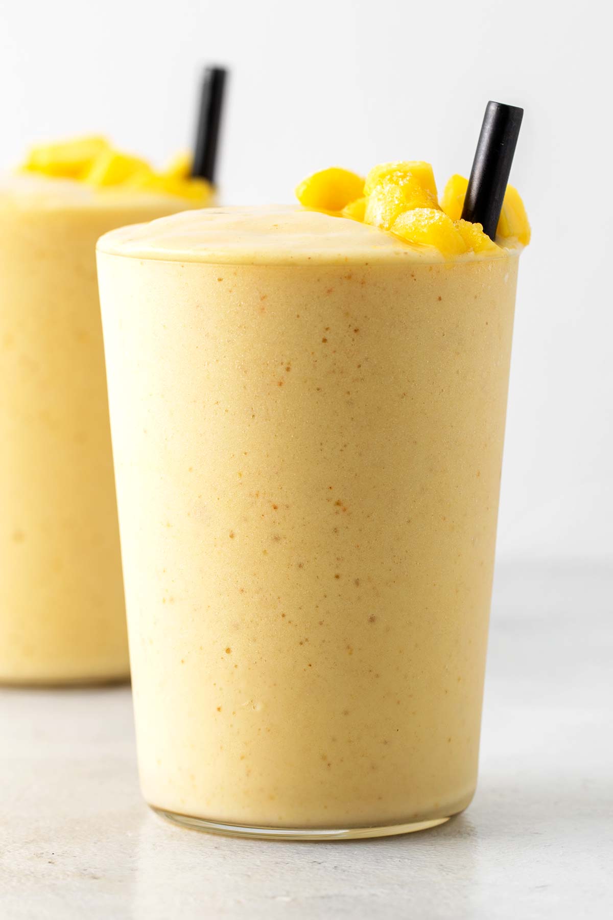 Mango collagen smoothies in cups.