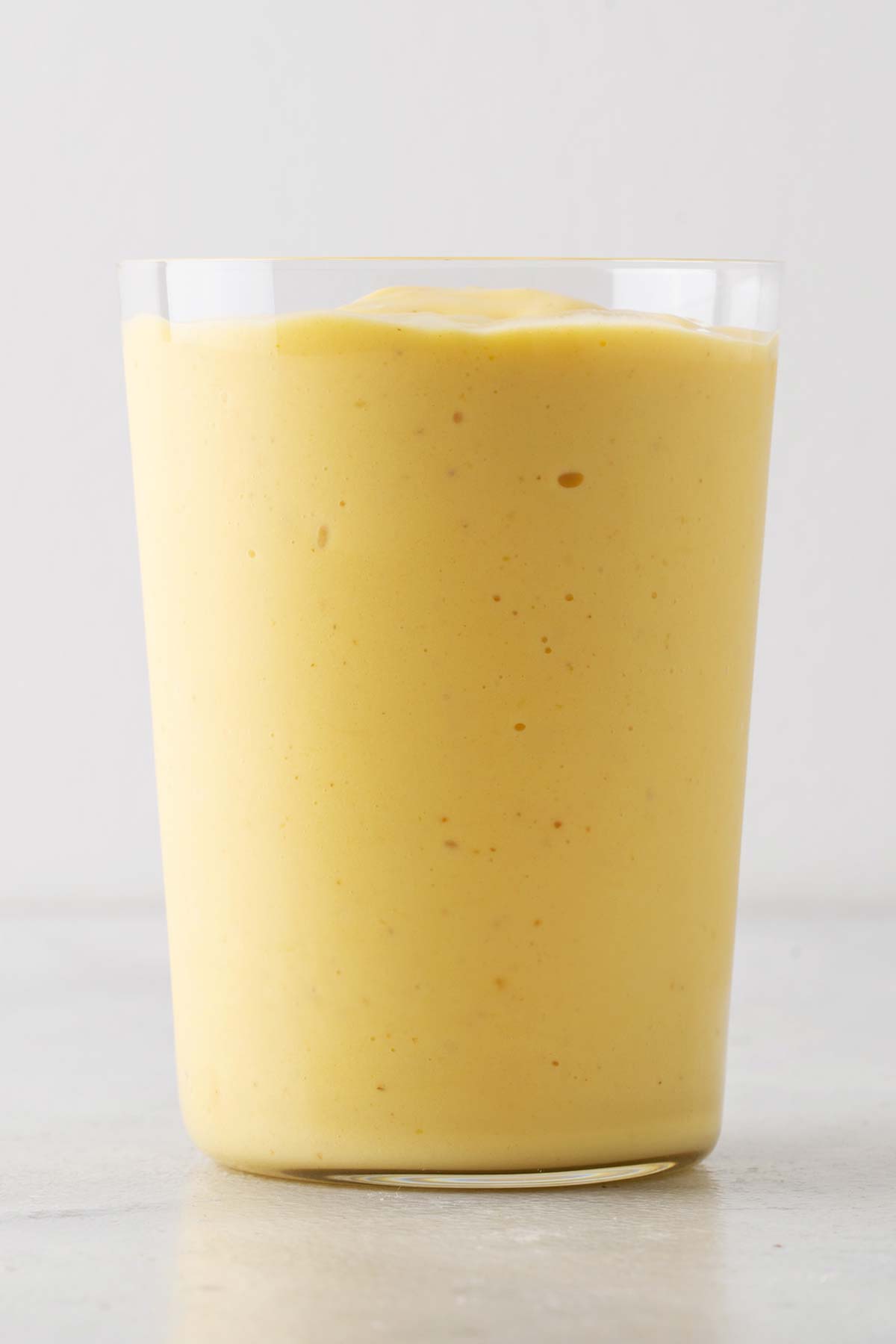 Mango yogurt smoothie in a cup.