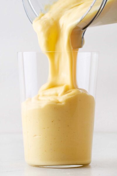 Yellow mango smoothie poured into a cup. 