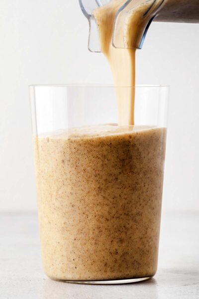 Peach smoothie poured into a cup.