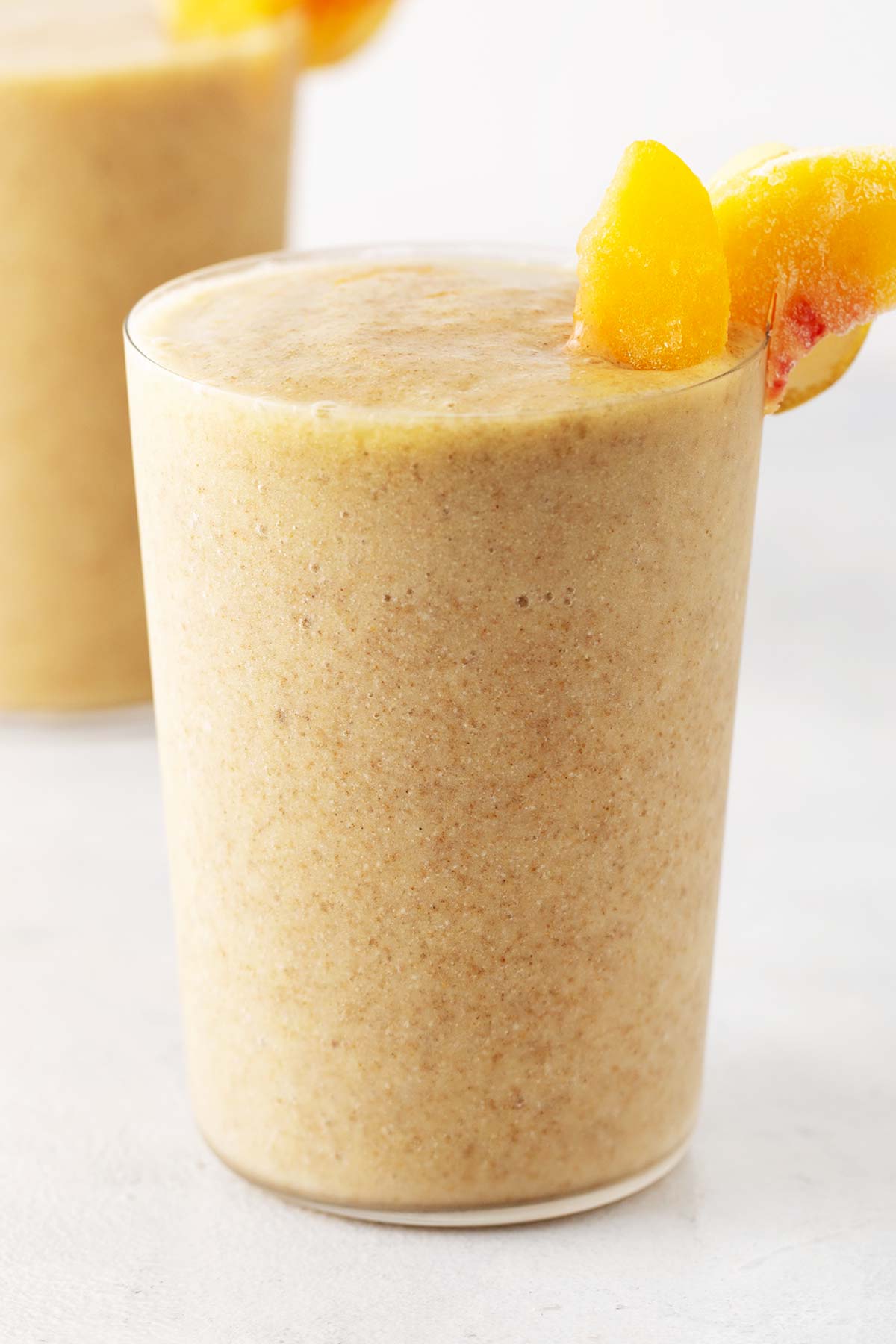 Peach smoothie in a glass.