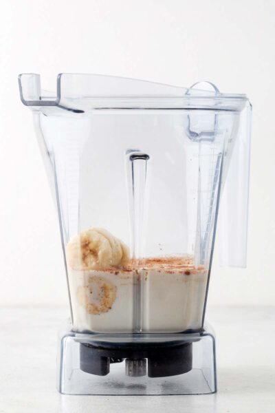 Bananas, cinnamon, and oat milk in a blender. 