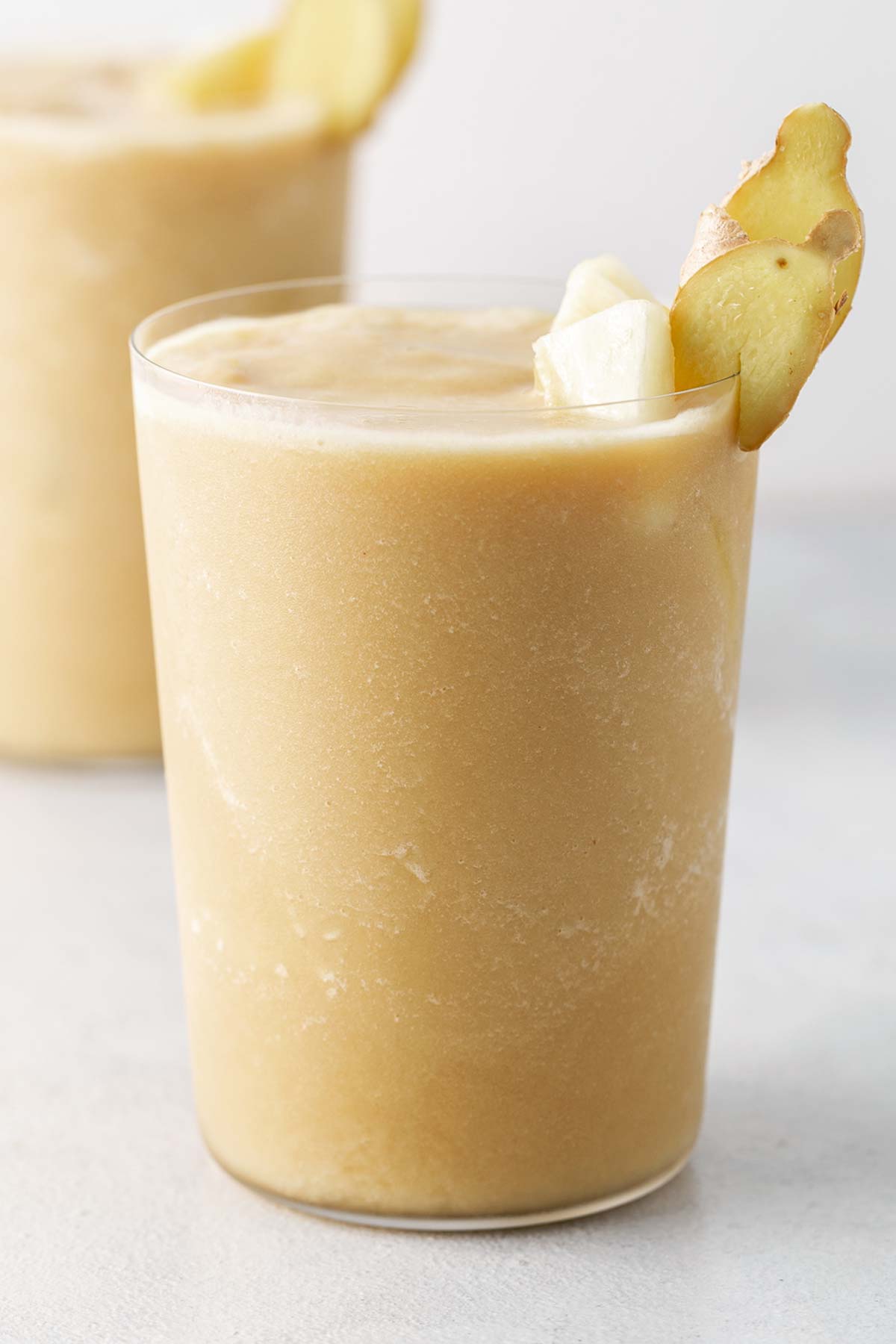 Pineapple ginger smoothie in a glass.