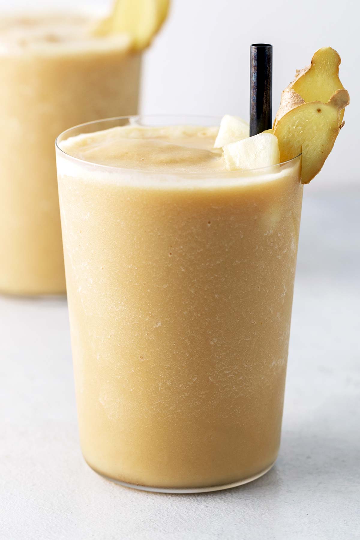 Pineapple ginger smoothie in a glass.