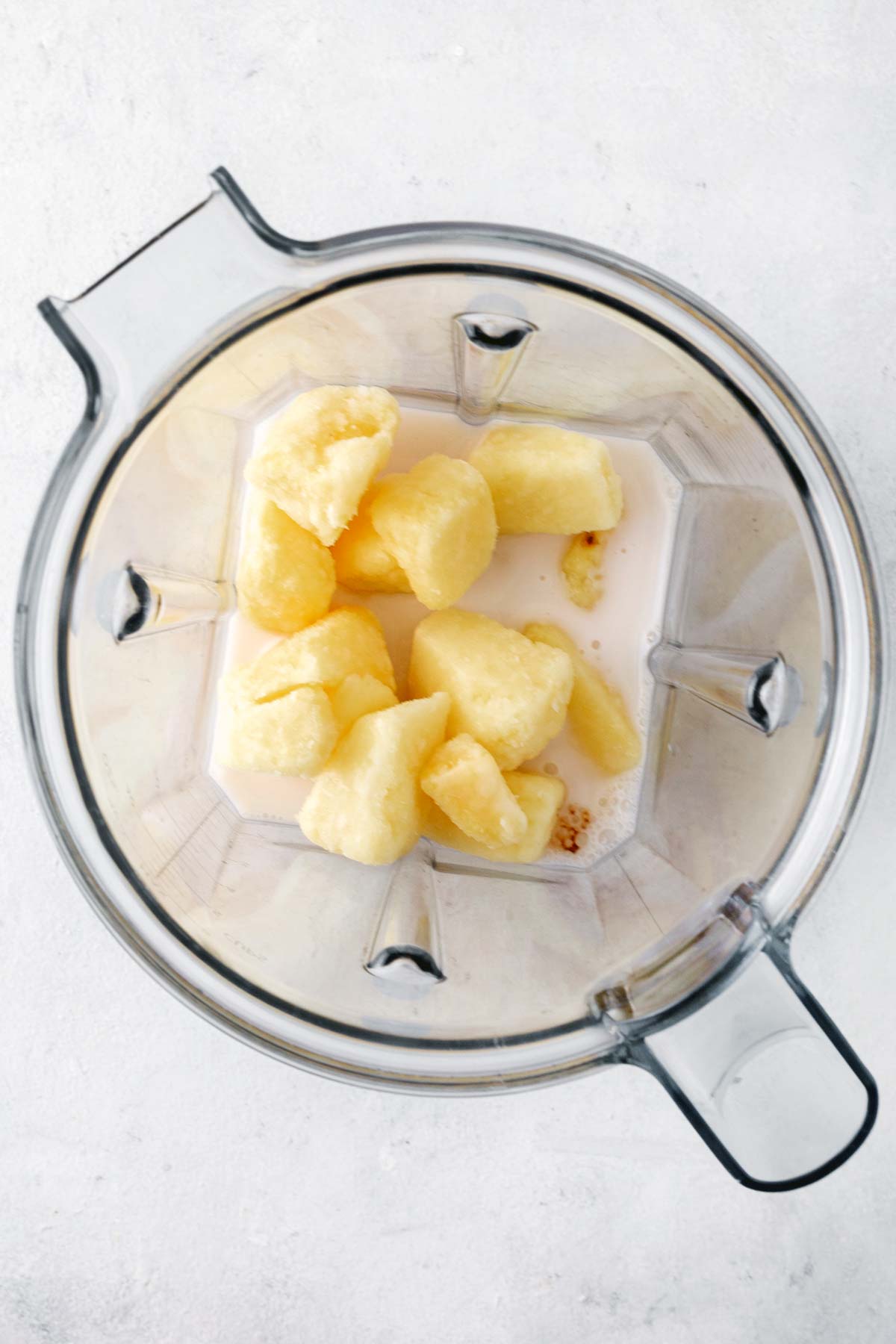 Pineapple ginger smoothie in a blender.