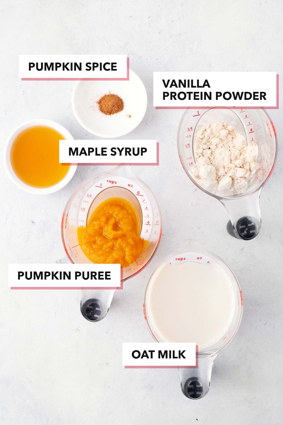 Ingredients for a pumpkin spice protein shake on a gray table.