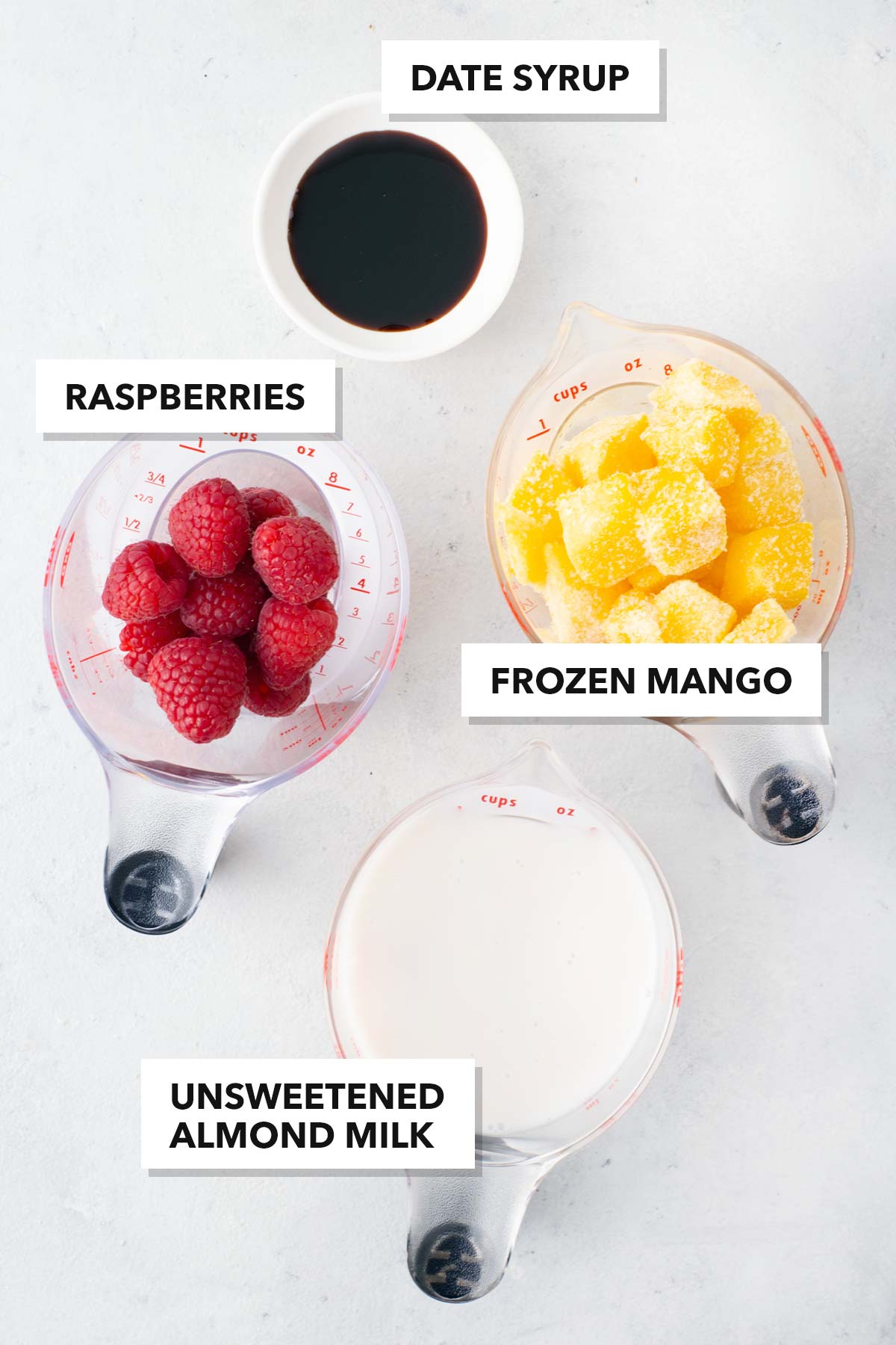Ingredients for a raspberry mango smoothie.