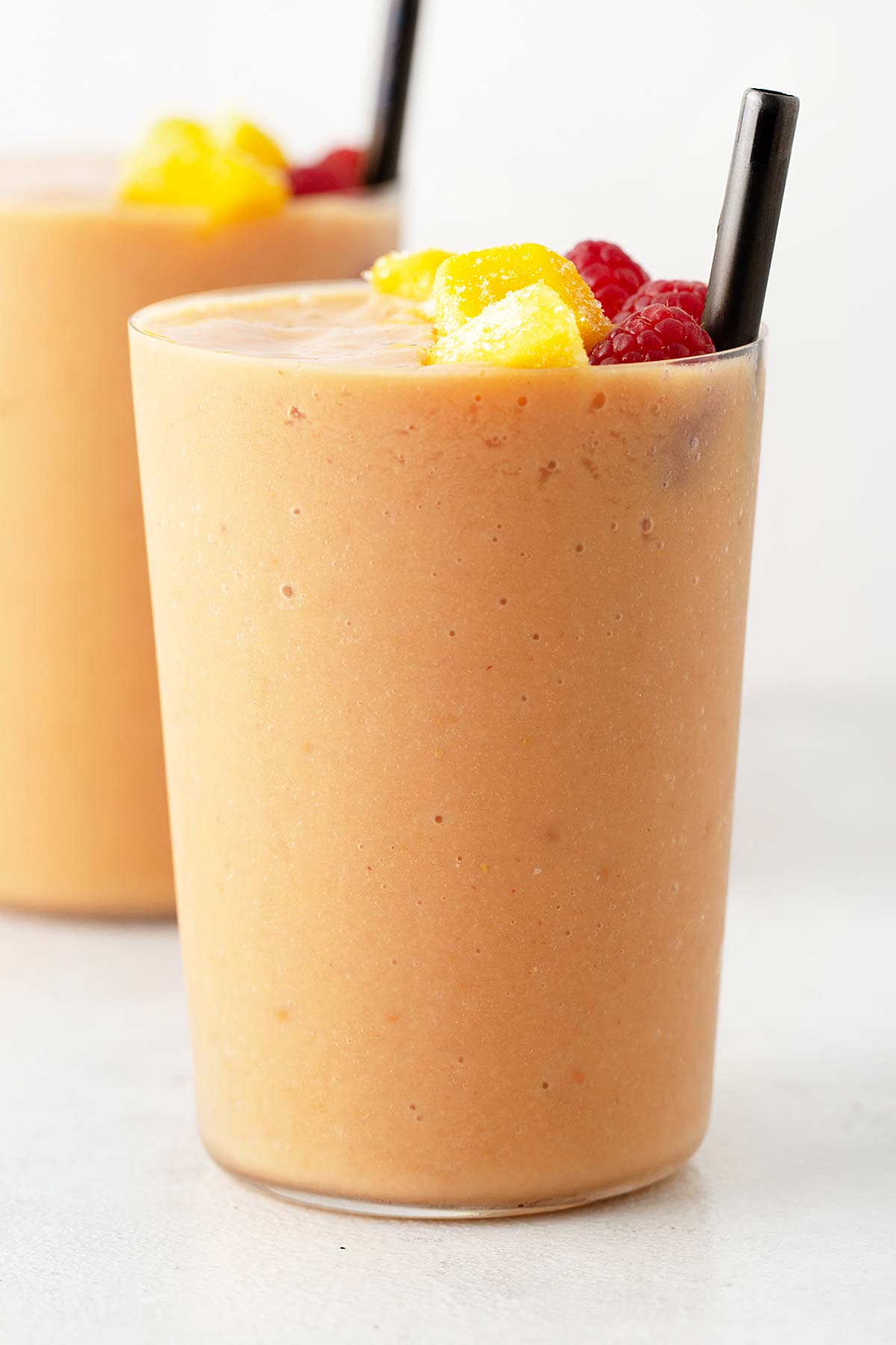 Raspberry mango smoothie in a glass.