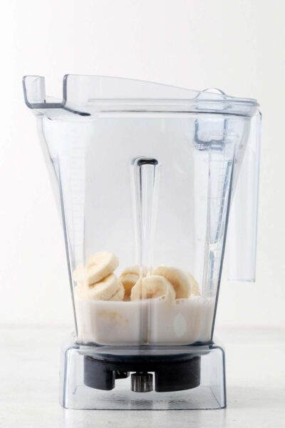 Bananas in a blender with milk.