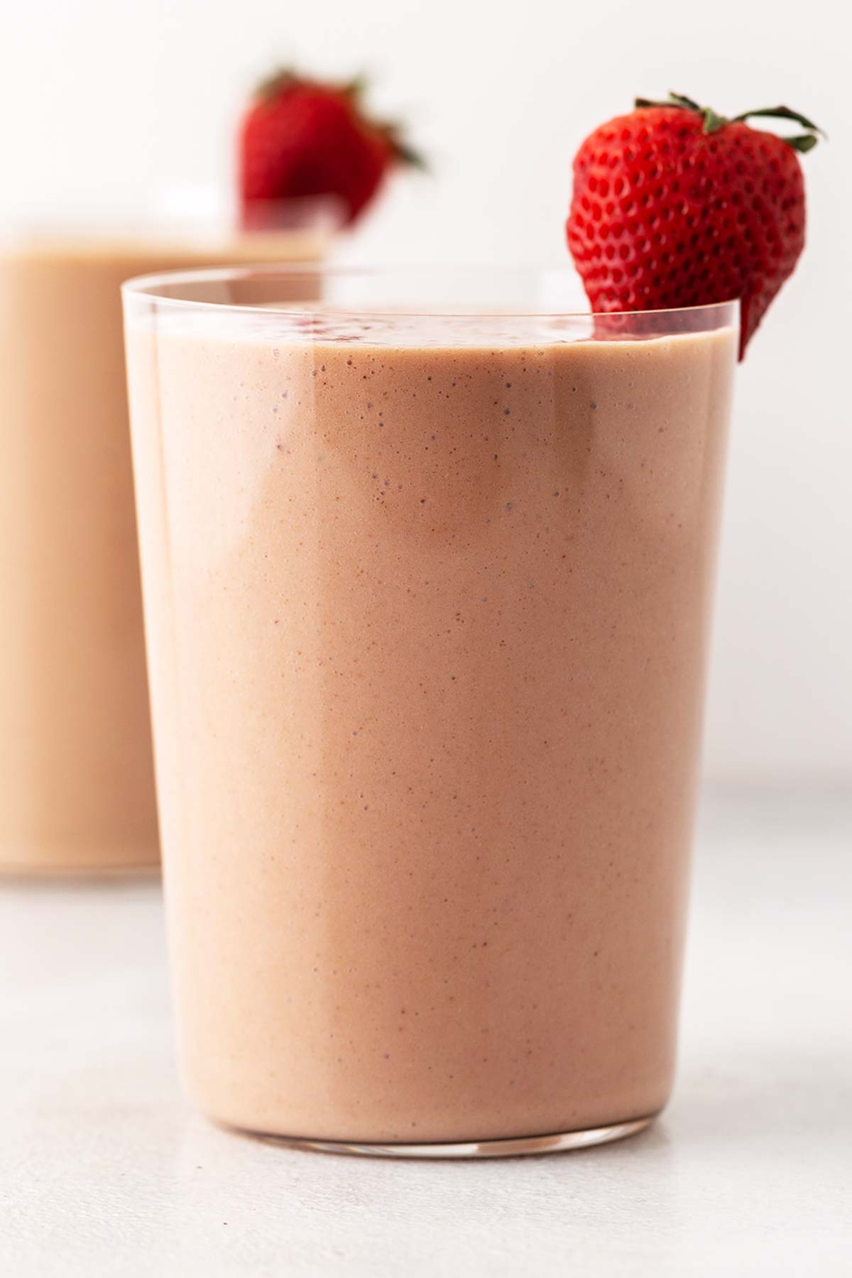 Strawberry banana protein shake in a glass.