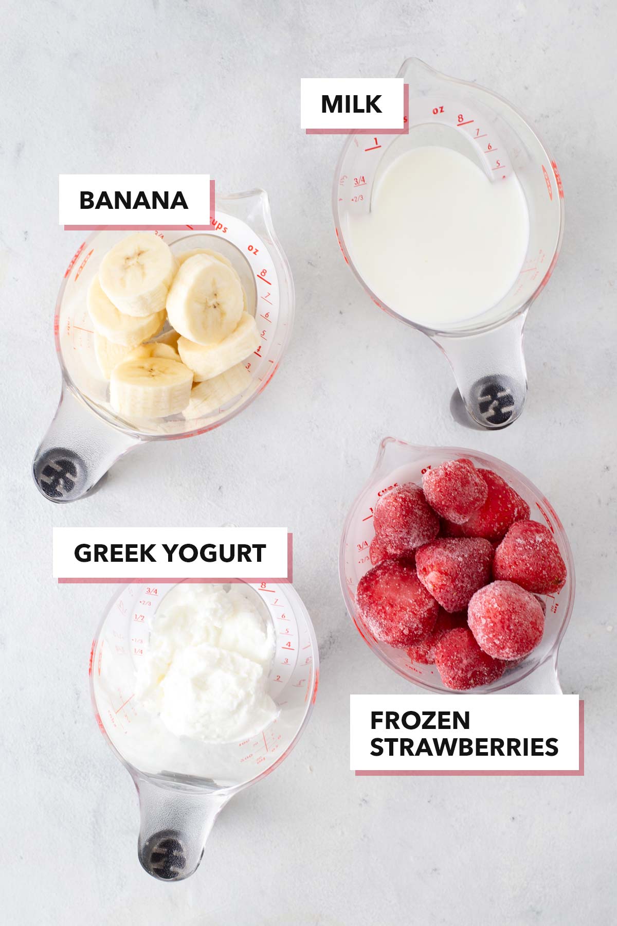 Ingredients to make a Strawberry banana smoothie on a table.